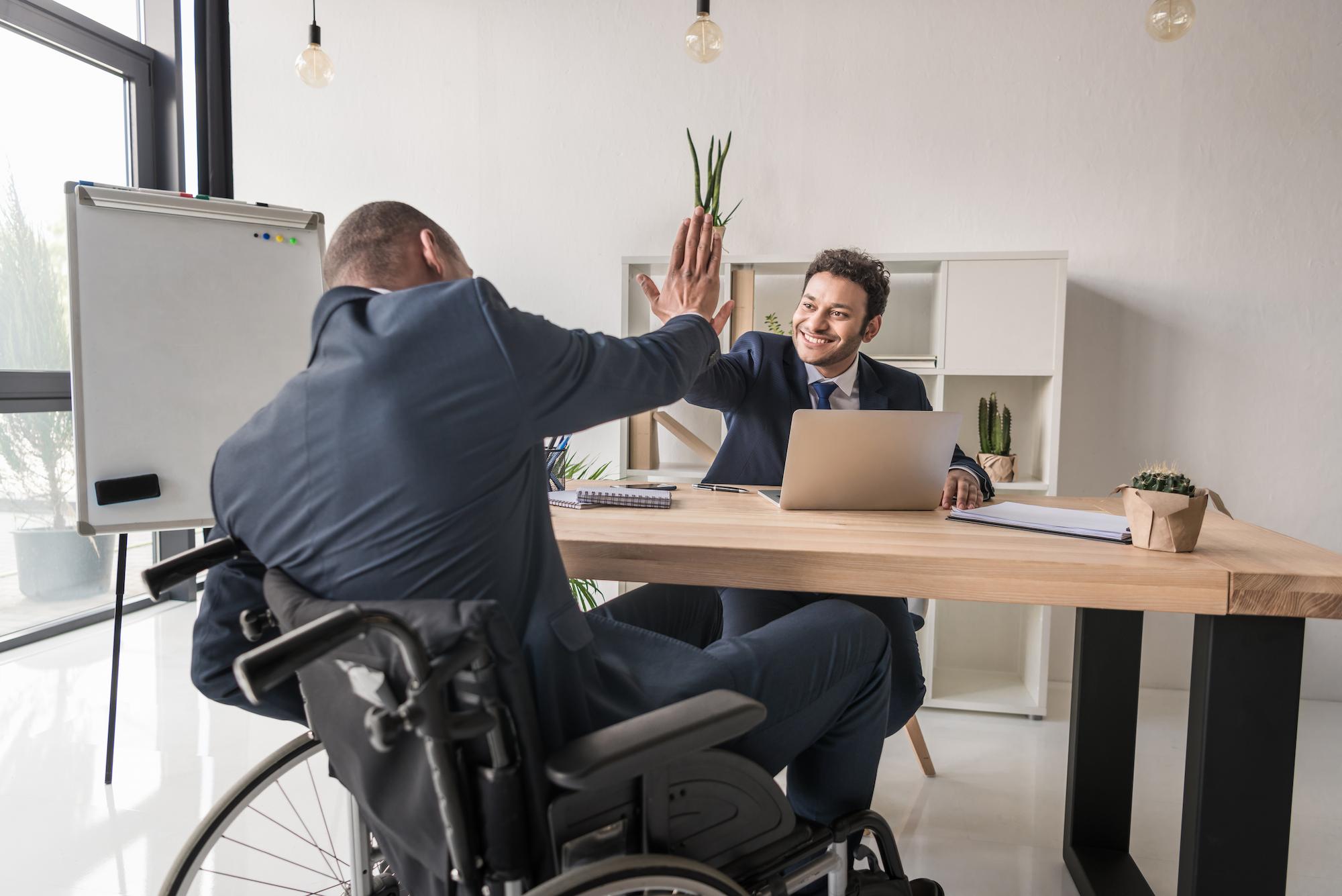 man with disability shaking hands with lawyer after maximizing social security disability benefits